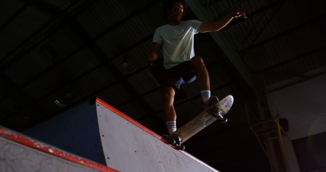 Skateboarder Performing Trick at Indoor Skate Park - Free Images, Stock Photos and Pictures on Pikwizard.com