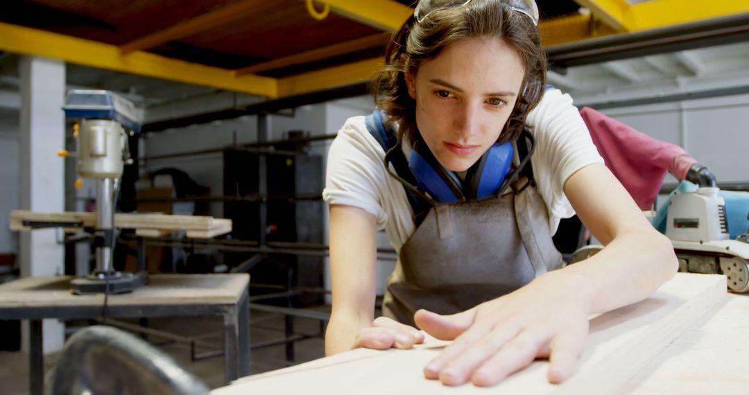 Focused Female Carpenter Working with Wood in Workshop - Free Images, Stock Photos and Pictures on Pikwizard.com