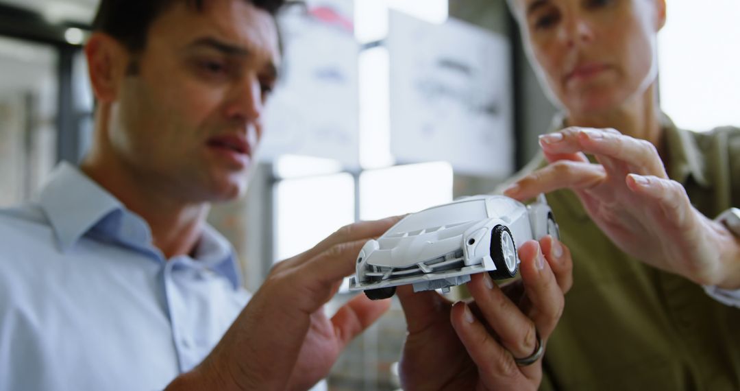 Engineers Examining Small Scale Car Model Prototype - Free Images, Stock Photos and Pictures on Pikwizard.com