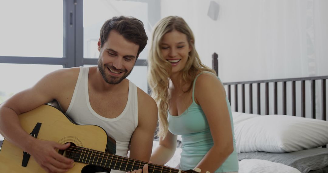 Couple Enjoying Acoustic Guitar Together at Home - Free Images, Stock Photos and Pictures on Pikwizard.com