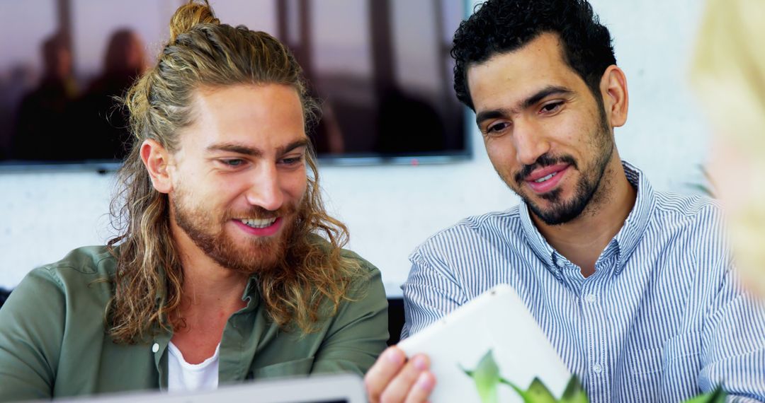 Two Men Collaborating with Tablet in Modern Office Environment