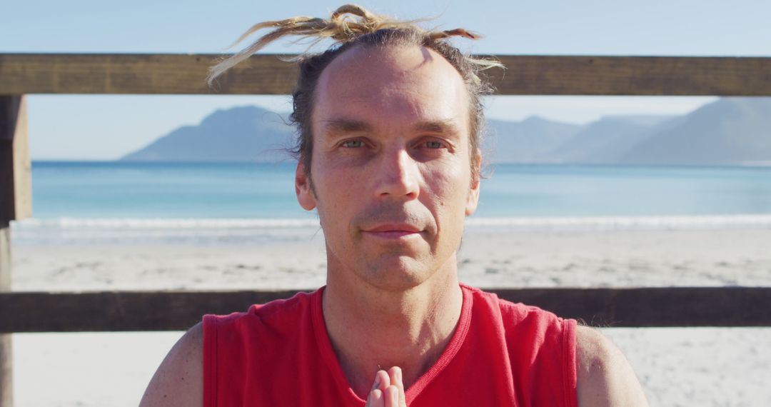 Man Practicing Yoga at Serene Beach with Mountains in Background - Free Images, Stock Photos and Pictures on Pikwizard.com