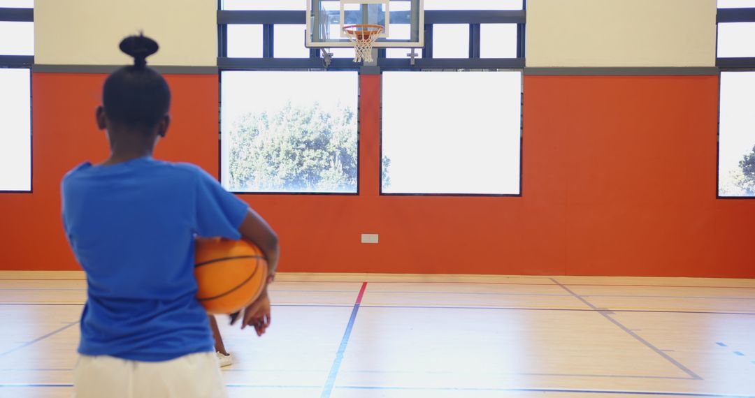 Youth Basketball Player Practicing in School Gym
