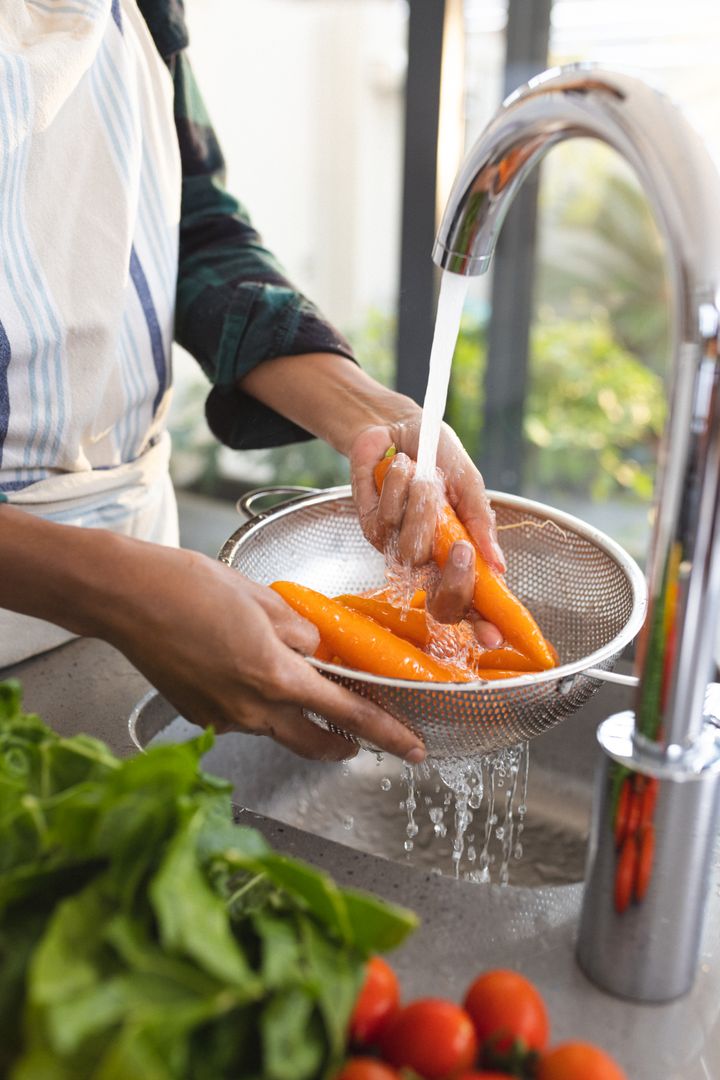 Man Washing Fresh Carrots in Kitchen Sink - Free Images, Stock Photos and Pictures on Pikwizard.com