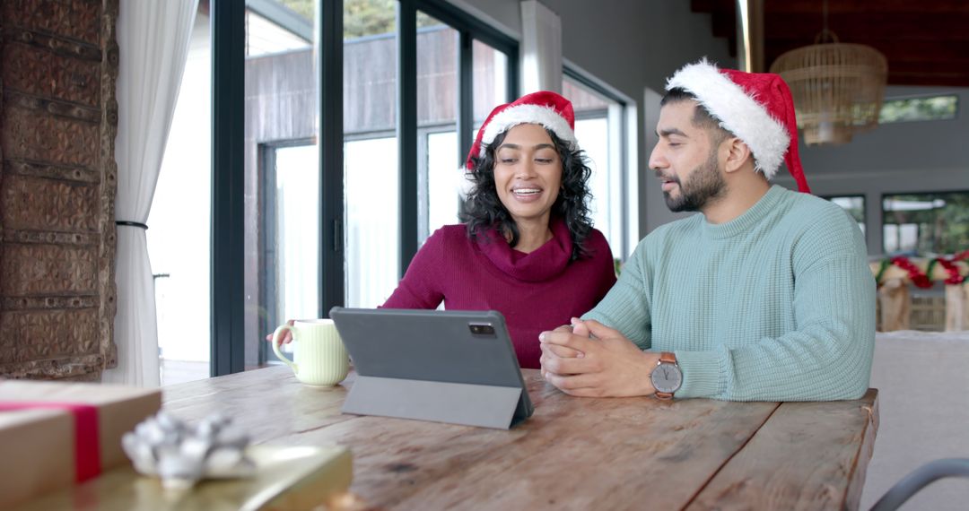 Couple Enjoying a Video Call During Christmas Celebration - Free Images, Stock Photos and Pictures on Pikwizard.com