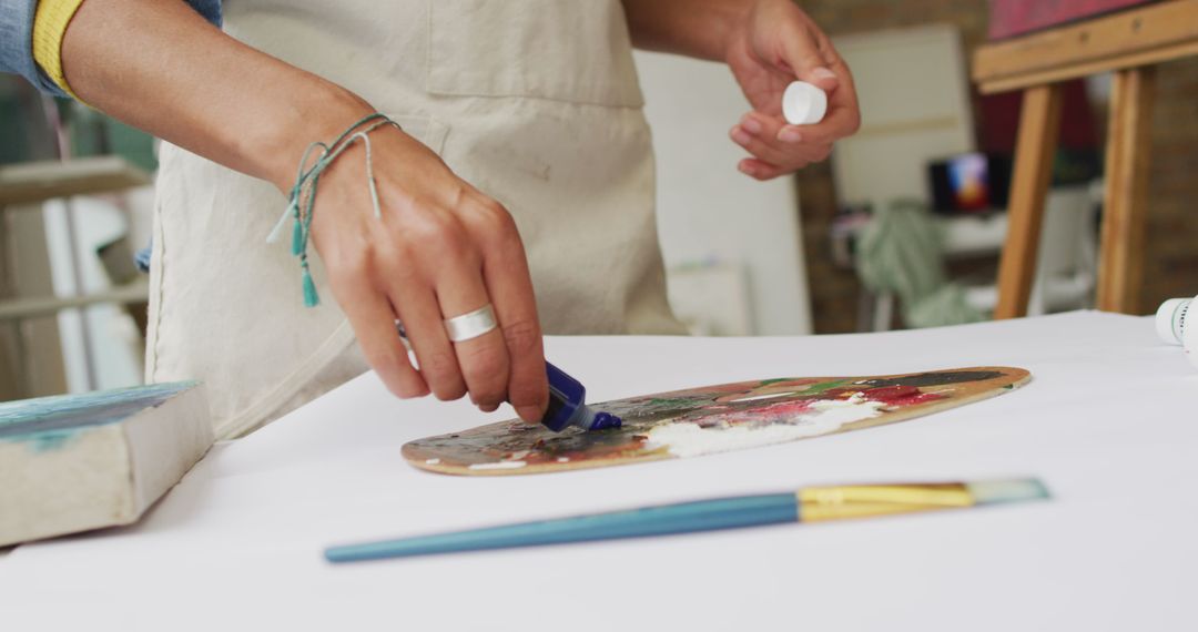 Artist Preparing Colorful Palette in Bright Studio
