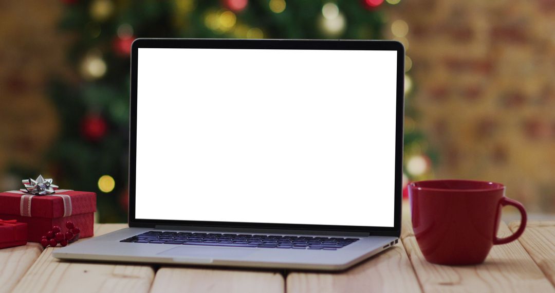 Laptop Displaying Blank Screen with Christmas Decor and Red Mug