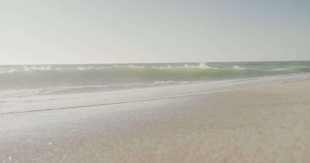 Serene Beach with Gentle Waves and Clear Sky - Free Images, Stock Photos and Pictures on Pikwizard.com