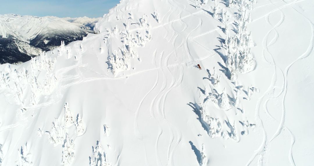 Aerial View of Skier Navigating Pristine Snowy Mountain - Free Images, Stock Photos and Pictures on Pikwizard.com