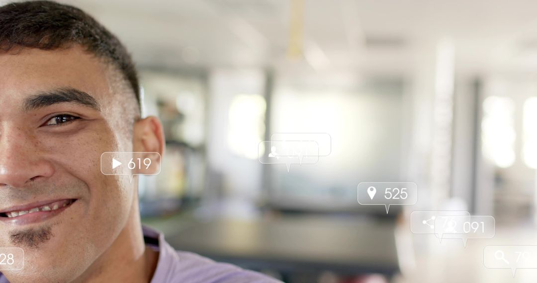 Smiling man in coworking space with social engagement icons, digital networking concept
