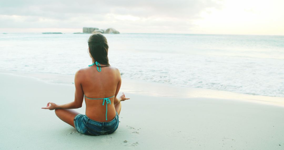 Rear view of woman performing yoga on beach 4k - Free Images, Stock Photos and Pictures on Pikwizard.com