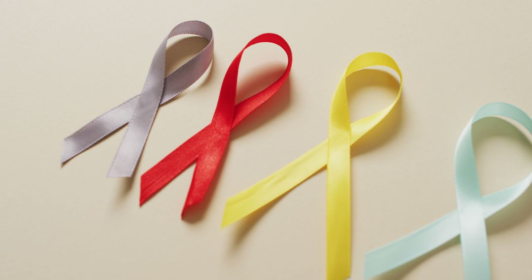 Image of close up of cancer ribbons on white background - Free Images, Stock Photos and Pictures on Pikwizard.com