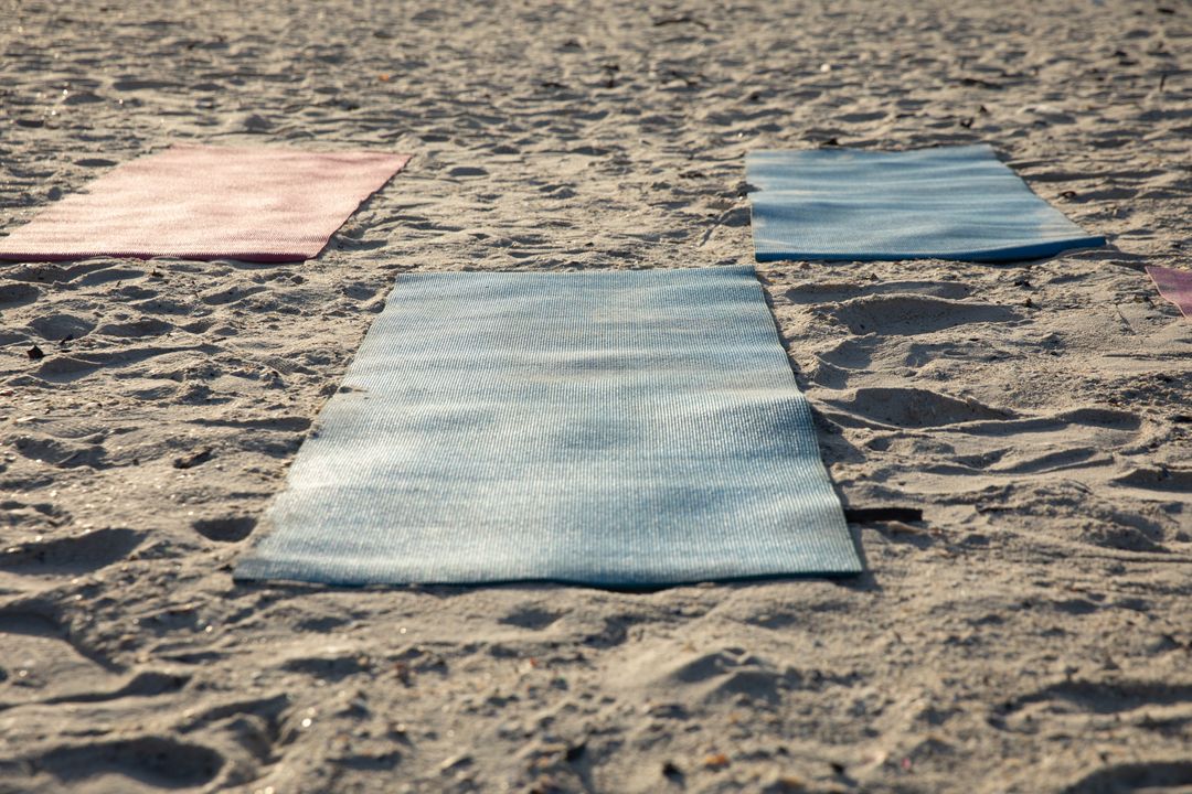Multiple yoga mats on the beach - Free Images, Stock Photos and Pictures on Pikwizard.com
