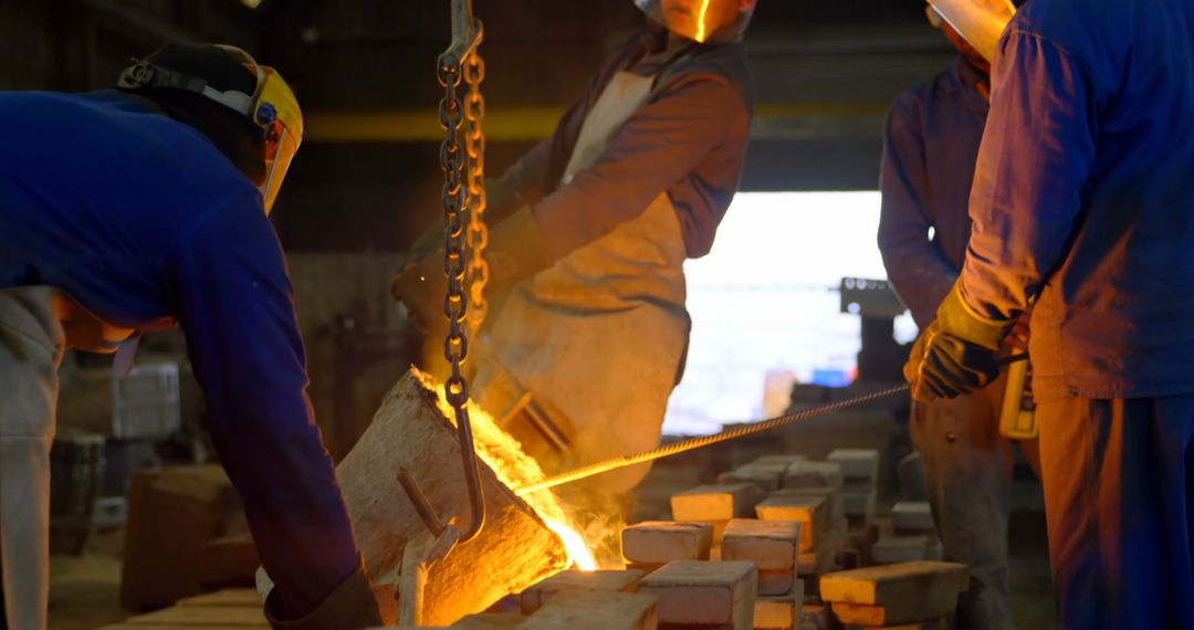 Workers Pouring Molten Metal in Factory Foundry - Free Images, Stock Photos and Pictures on Pikwizard.com