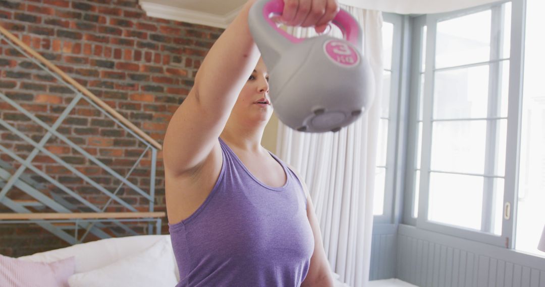 Woman Lifting Kettlebell During Home Exercise Session - Free Images, Stock Photos and Pictures on Pikwizard.com