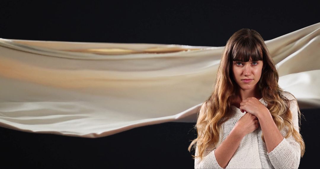 Serene Woman Contemplating with Floating Cloth Backdrop