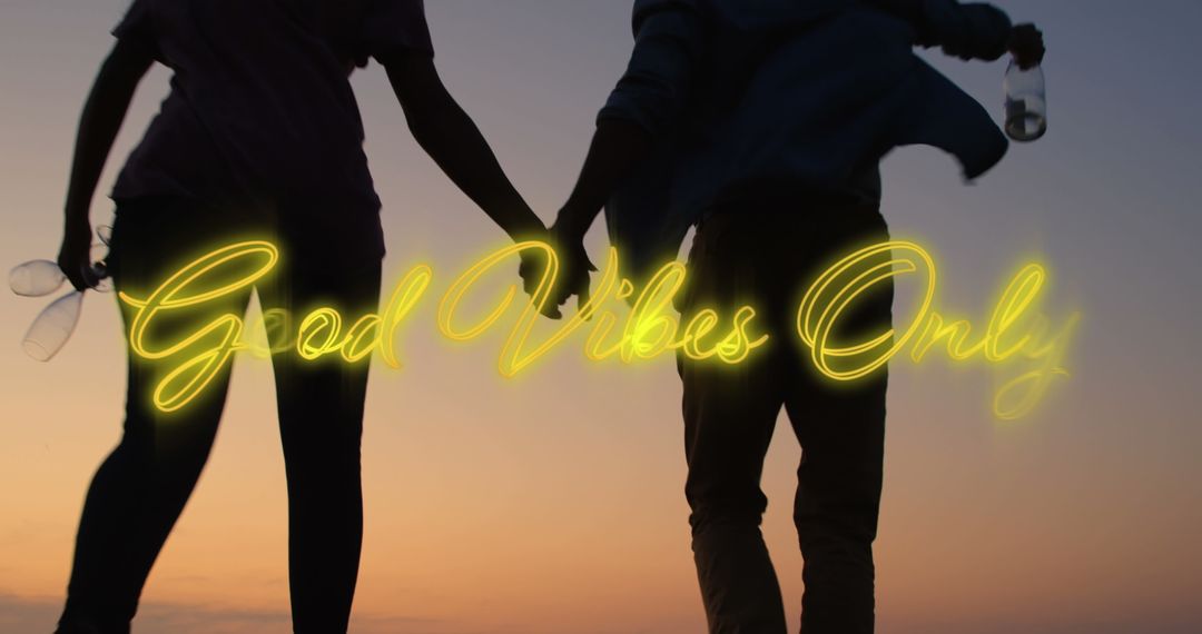 Couple Holding Hands at Sunset Symbolizing Good Vibes