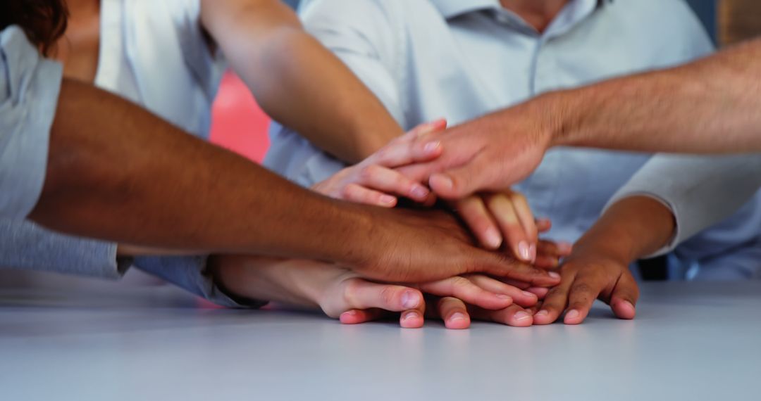 Diverse Team Celebrating Unity with Hands Joined, Harmony in Workspace