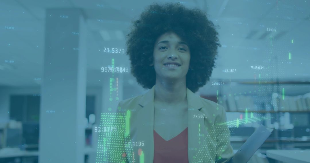 Confident businesswoman holding documents in modern open-plan office with finance data overlay