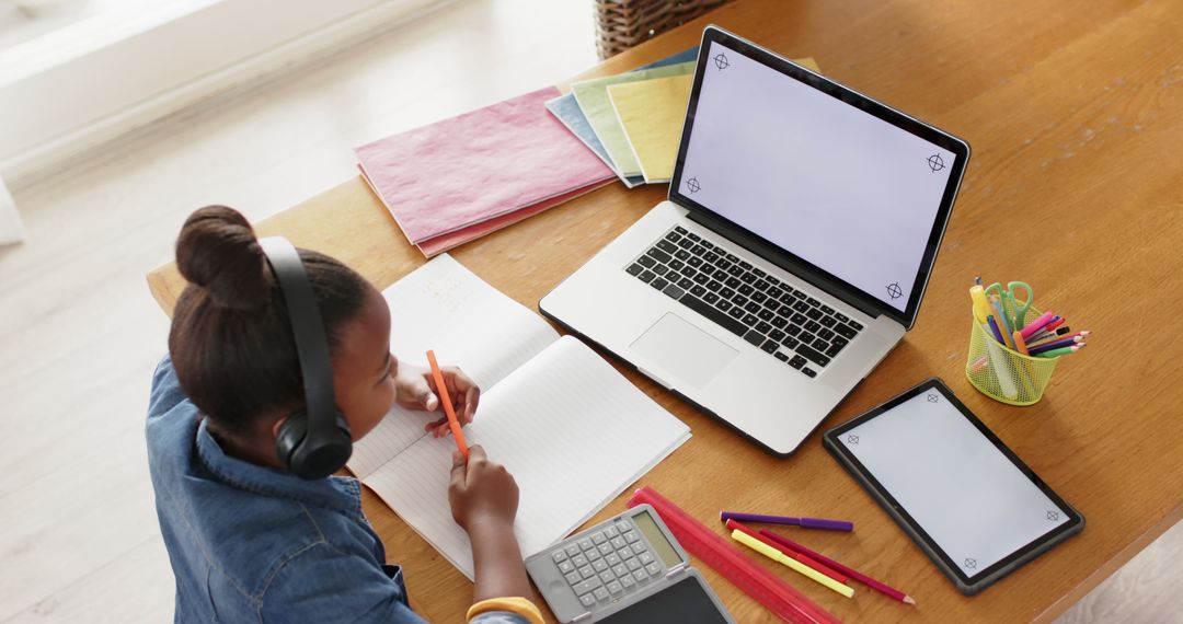 Girl Engaged in Virtual School Class at Home Desk