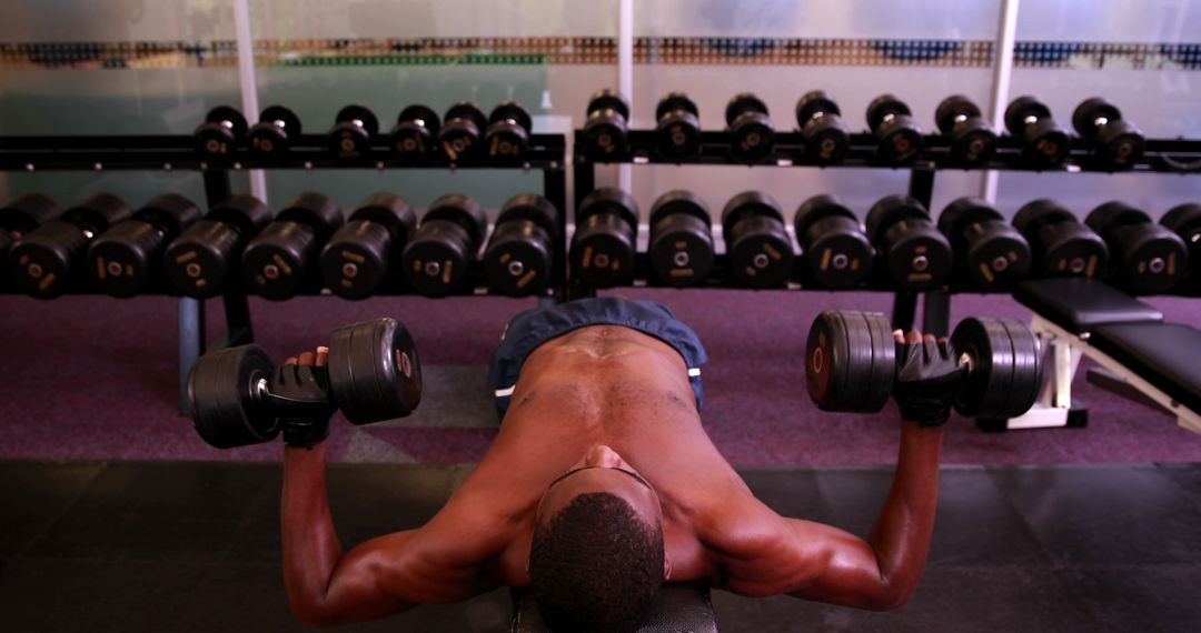 Man Working Out with Dumbbells in a Gym - Free Images, Stock Photos and Pictures on Pikwizard.com