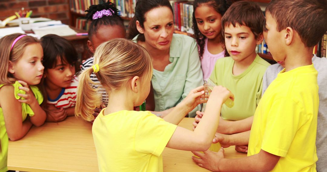 Teacher Guiding Children in Science Experiment in Classroom - Free Images, Stock Photos and Pictures on Pikwizard.com