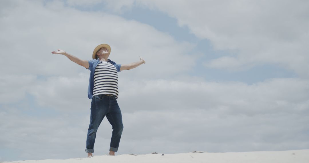 Joyful Man with Hat Enjoying Freedom at Beach - Free Images, Stock Photos and Pictures on Pikwizard.com