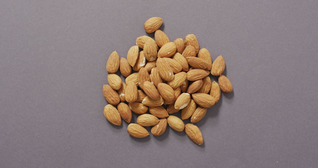 Raw Whole Almonds on Neutral Grey Backdrop for Healthy Eating