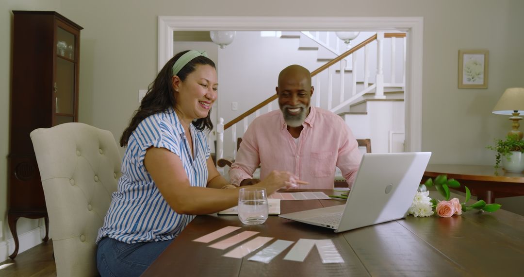 Senior Couple Using Laptop for Home Color Planning