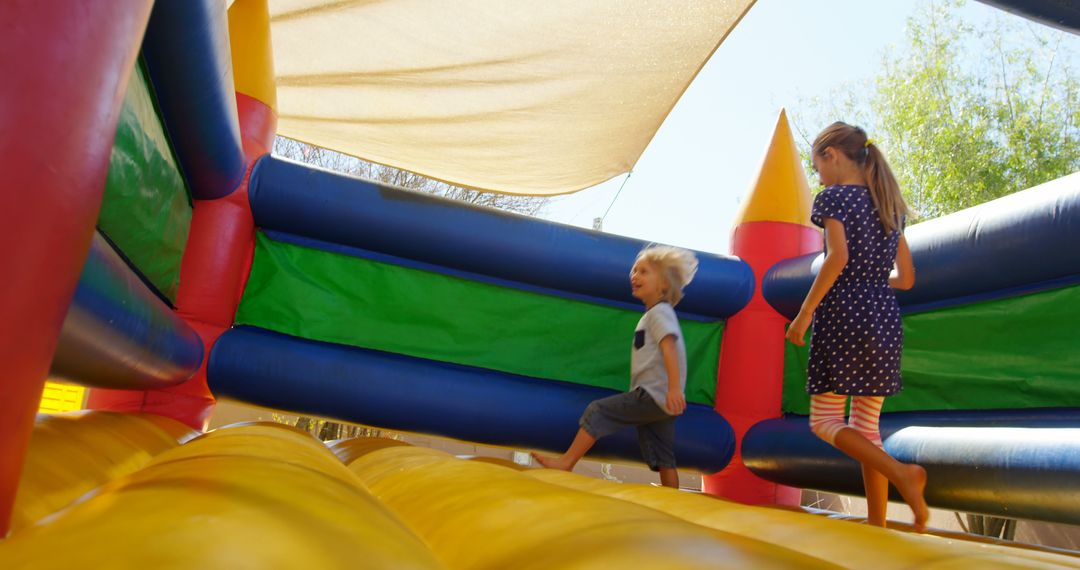 Children Playing on Inflatable Bouncy Castle Outdoors - Free Images, Stock Photos and Pictures on Pikwizard.com