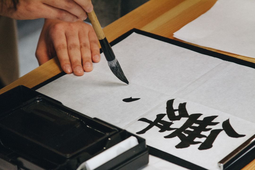 Hands Writing Japanese Calligraphy on White Paper with Brush - Free Images, Stock Photos and Pictures on Pikwizard.com