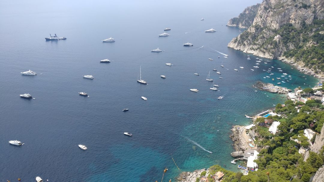 Aerial View of Boats on Crystal Blue Ocean Near Rocky Coastline - Free Images, Stock Photos and Pictures on Pikwizard.com