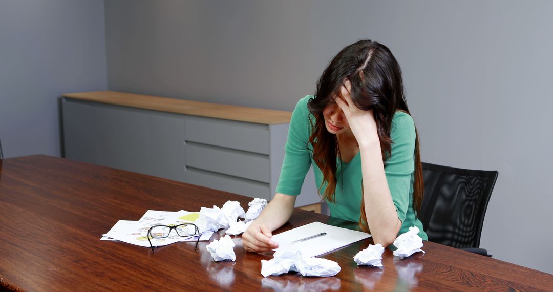 Frustrated Woman Wrapping Up Crumpled Paper in Office Meeting Room - Free Images, Stock Photos and Pictures on Pikwizard.com