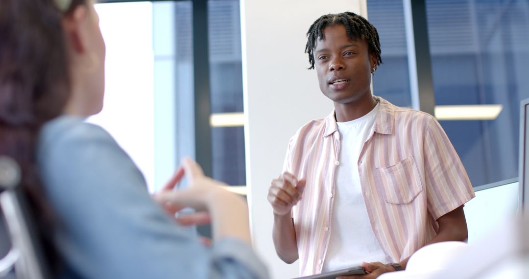 Focused Multiracial Team Discussing Business Strategy in Modern Office