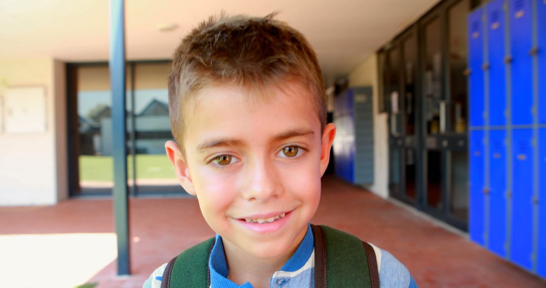 Smiling Boy with Backpack Standing in School Hallway - Free Images, Stock Photos and Pictures on Pikwizard.com