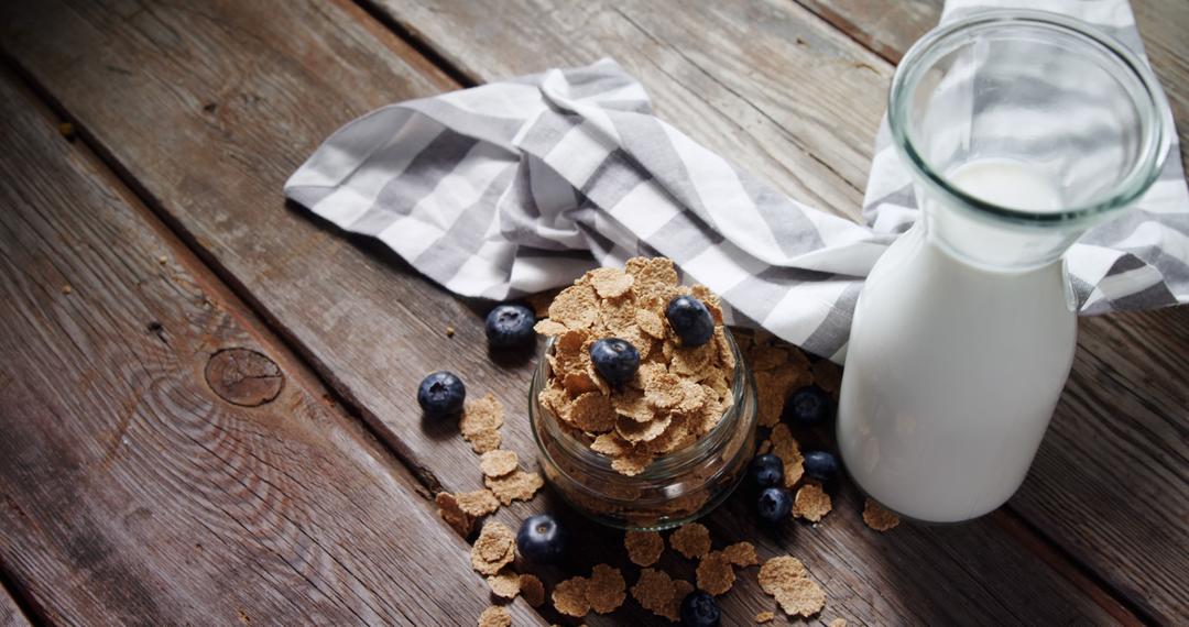 Fresh Breakfast Scene with Cereal, Blueberries, and Milk on Rustic Wooden Table - Free Images, Stock Photos and Pictures on Pikwizard.com