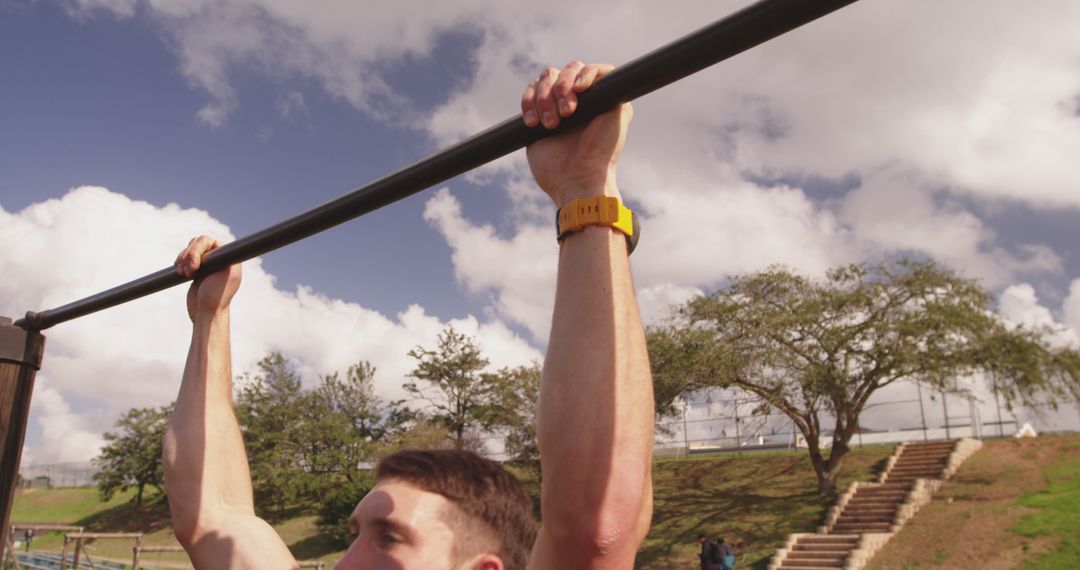 Young Man Doing Pull-Ups Outdoors - Free Images, Stock Photos and Pictures on Pikwizard.com