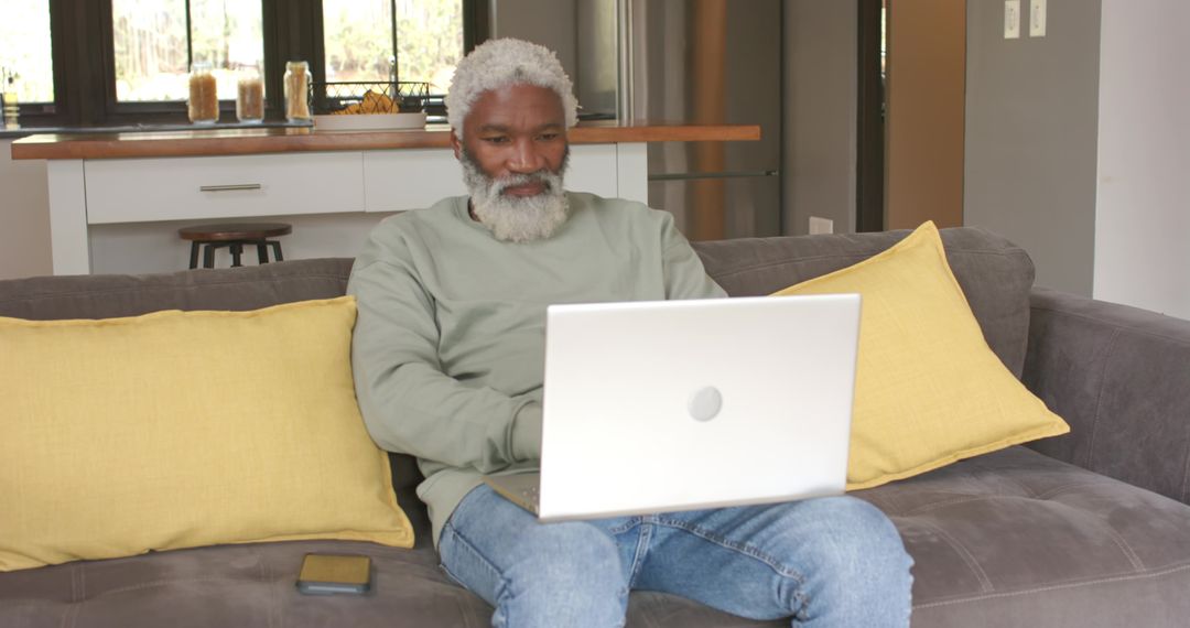 Senior African American Man Using Laptop at Home for Remote Work