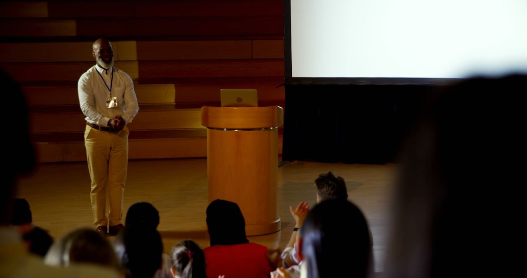 Confident Businessman Receives Applause in Seminar Hall - Free Images, Stock Photos and Pictures on Pikwizard.com