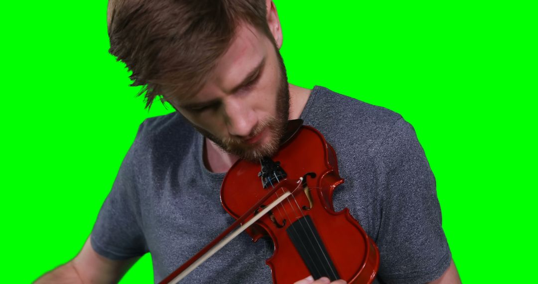 Focused Man Playing Violin Against Green Screen Background - Free Images, Stock Photos and Pictures on Pikwizard.com