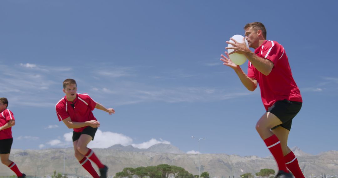 Rugby Players in Action during Training under Clear Blue Sky - Free Images, Stock Photos and Pictures on Pikwizard.com