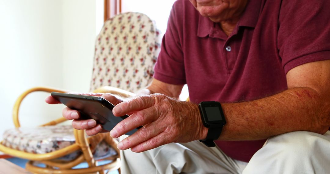 Senior Man Using Tablet in Comfortable Retirement Home - Free Images, Stock Photos and Pictures on Pikwizard.com