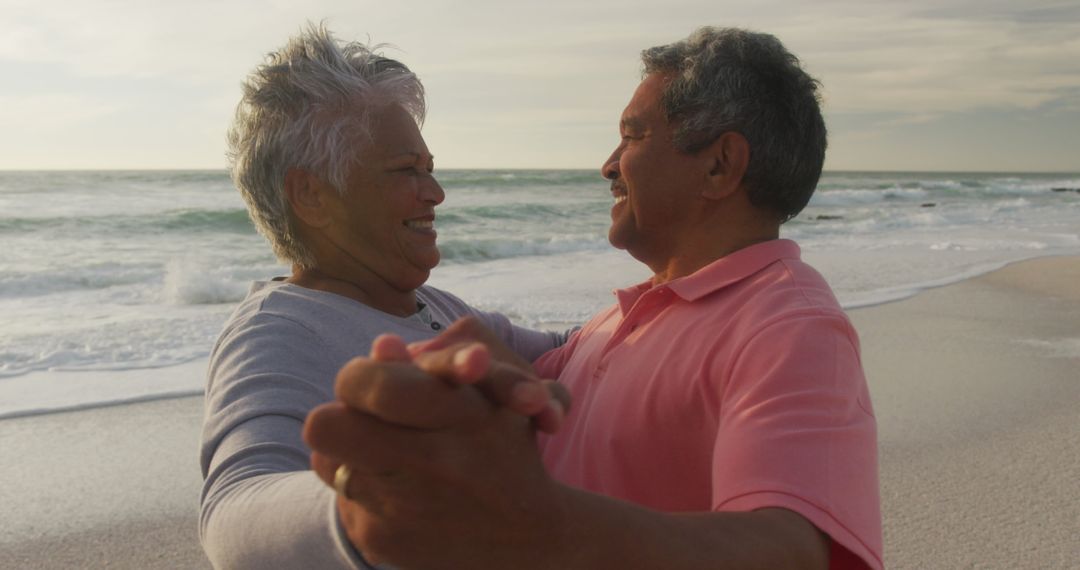 Senior Couple Enjoying Dance on Beach during Sunset