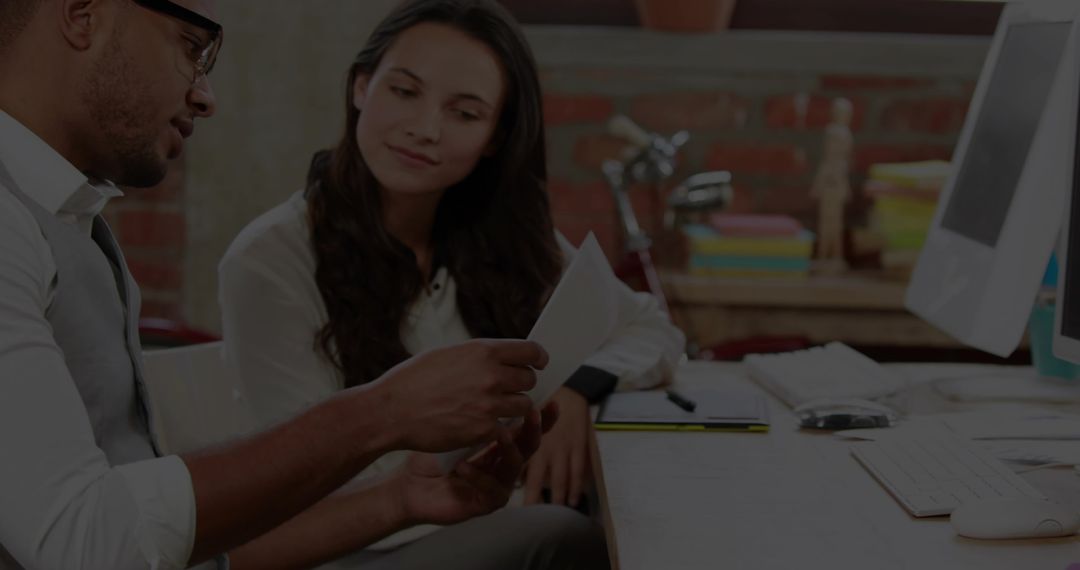 Office Collaboration Examining Documents at Workplace
