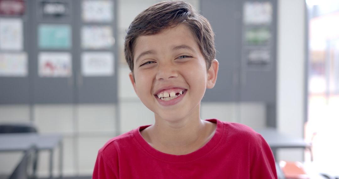Young Boy Smiling in Bright Classroom Environment
