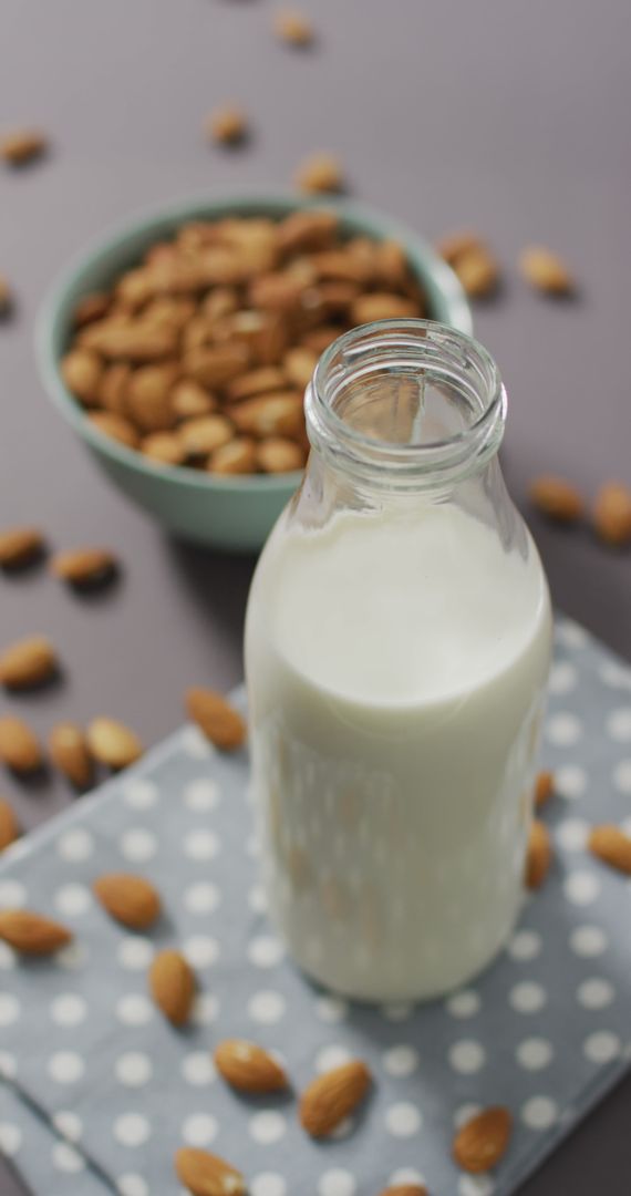 Fresh Almond Milk with Bowl of Whole Almonds on Polka Dot Cloth