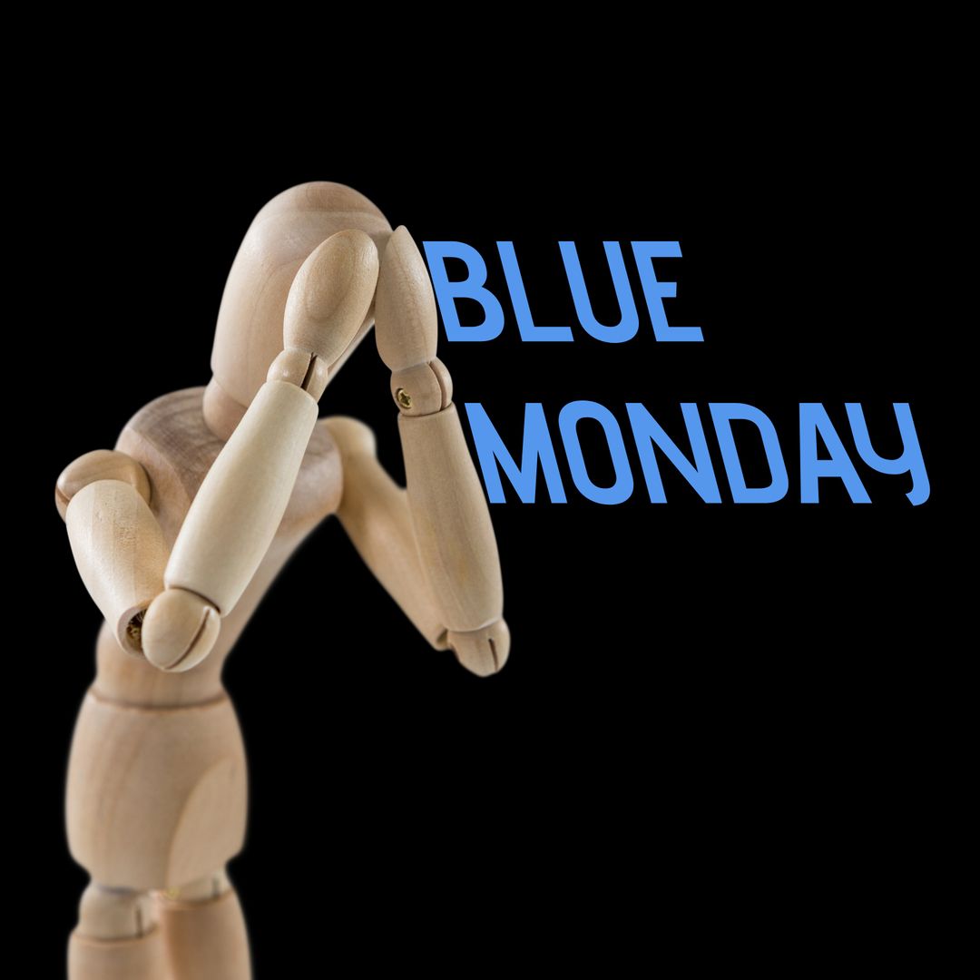 Wooden Figurine Expressing Sadness with Blue Monday Text