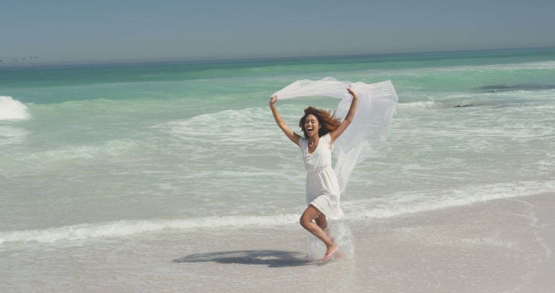 Joyful Woman at Beach with White Fabric in the Breeze - Free Images, Stock Photos and Pictures on Pikwizard.com