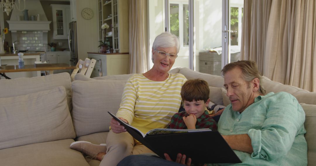 Grandparents Reading Storybook to Grandson on Sofa - Free Images, Stock Photos and Pictures on Pikwizard.com