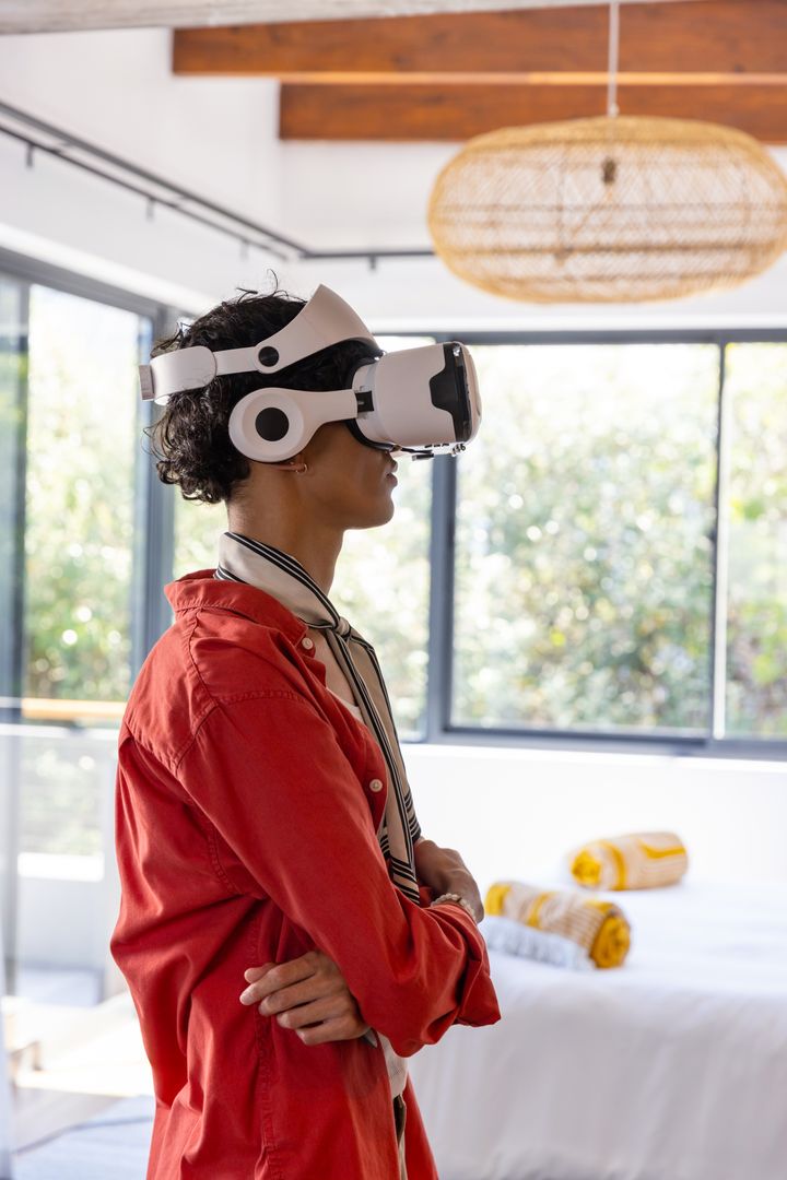 Man Using VR Headset in Sunlit Modern Bedroom